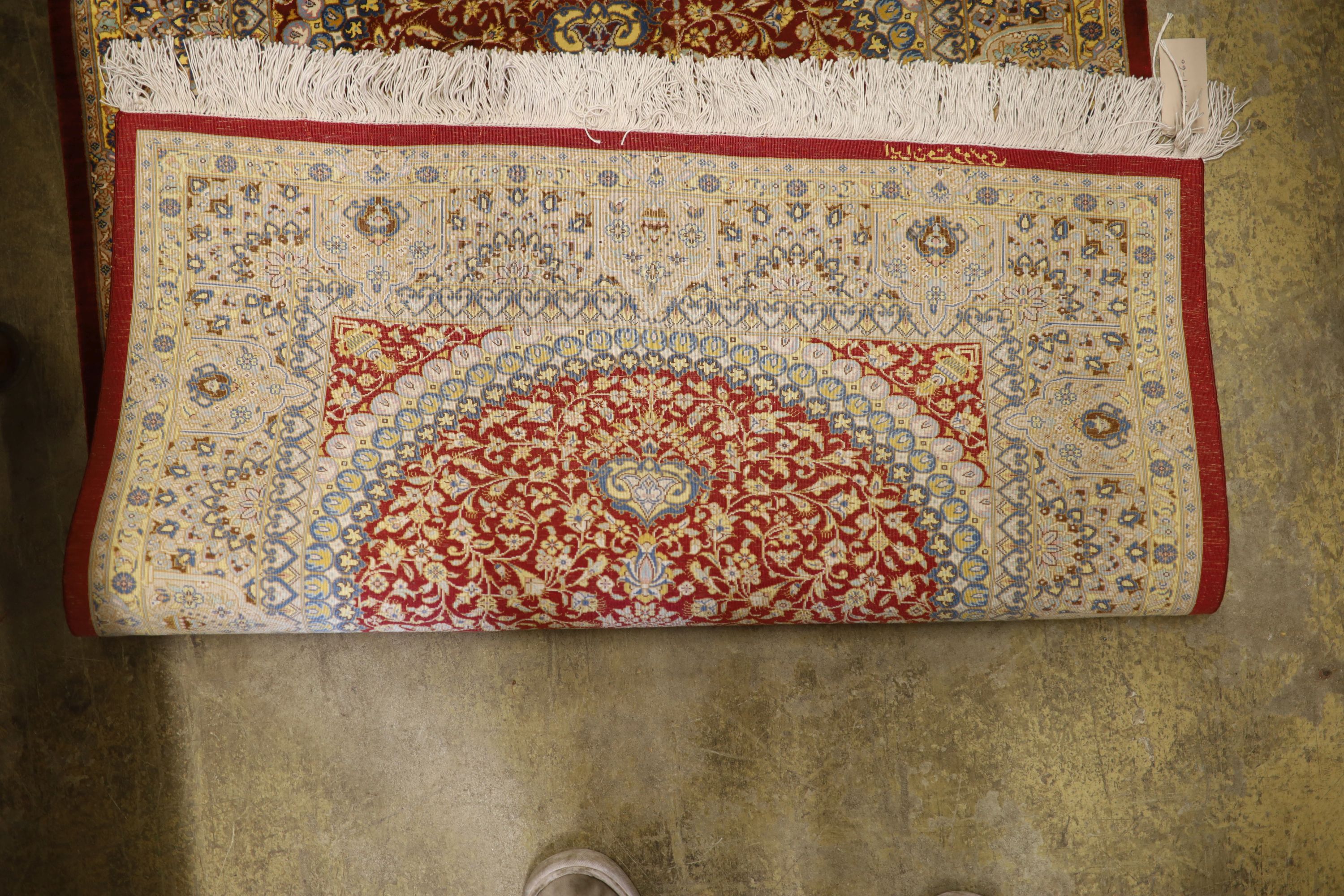 A Persian part red ground silk multi-floral patterned rug, 110 x 80cm